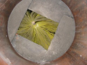 View down chimney pot showing sweeps brush trapped behind projecting slates