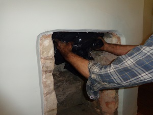 Inserting bag into chimney