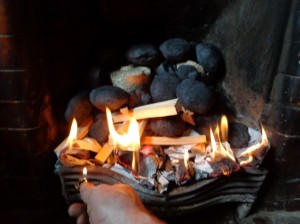 a hand with lighter igniting paper
