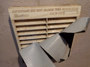 A wall vent covered in gaffa tape